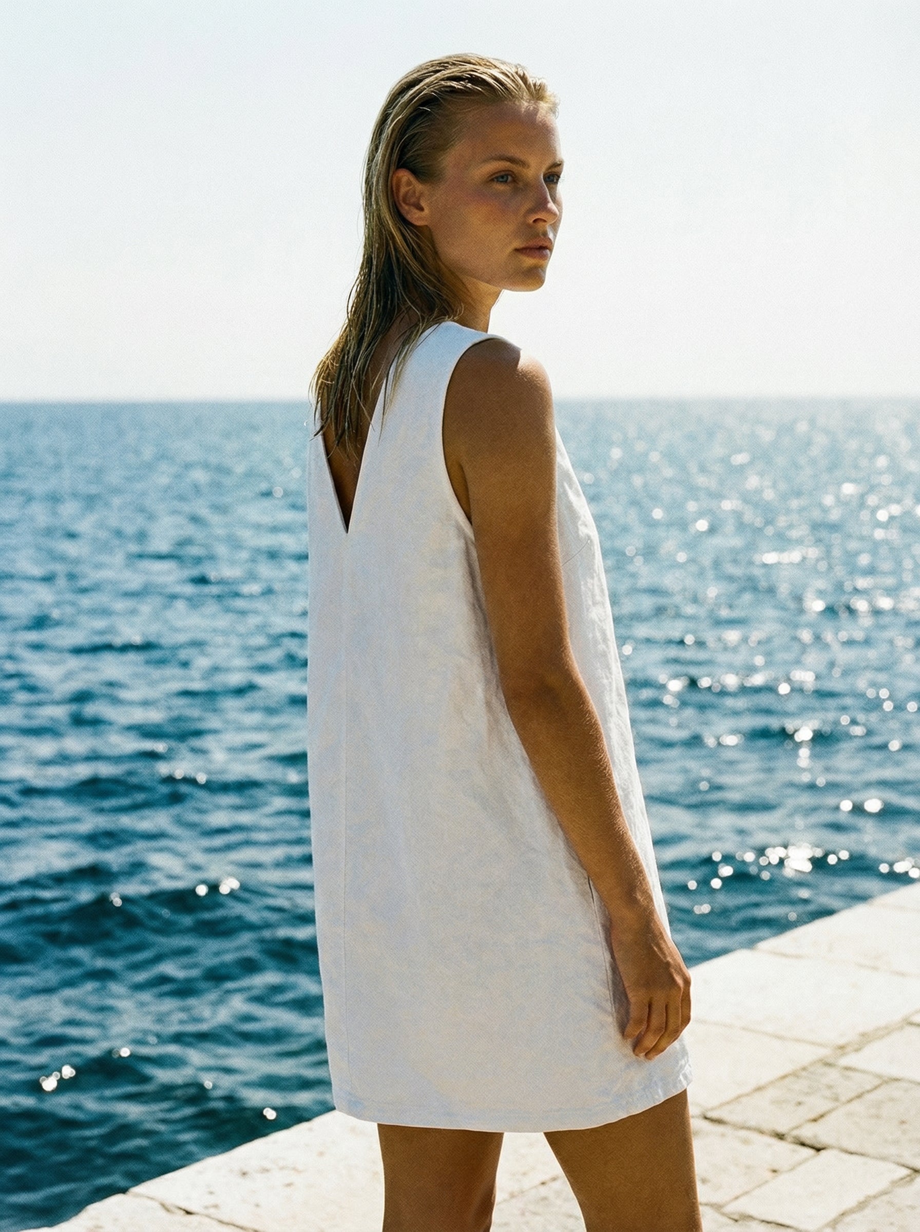 Britt_mykonos_in_white_denim_v_neck_ION_dress_side_view.jpg