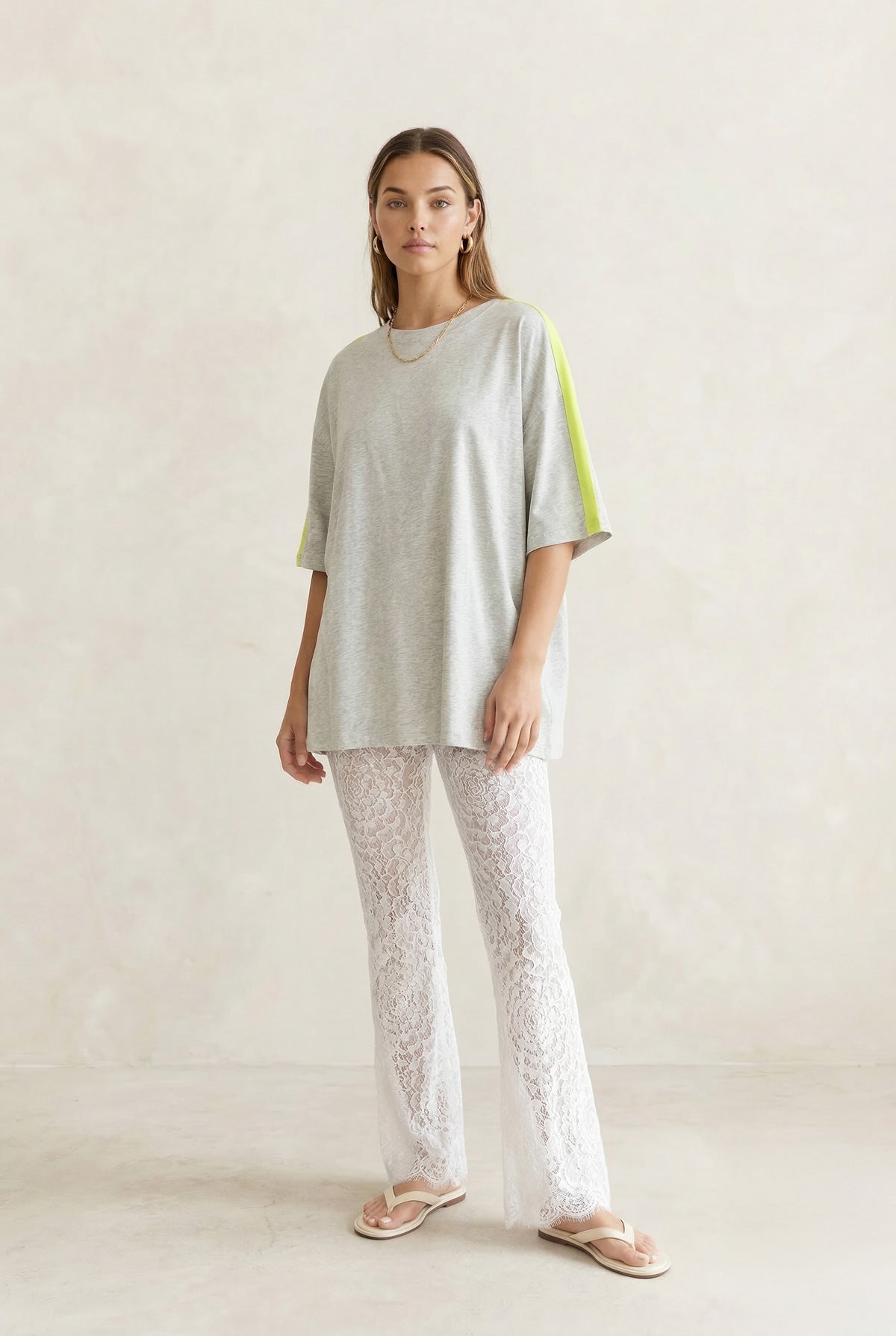 White Lace Pants with scalloped hem shown on model also wearing a grey tshirt with neon yellow stripe